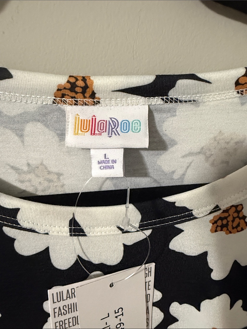 LuLaRoe Black Short Sleeve Tee with White and Golden Daisy Print - Picture 3 of 5